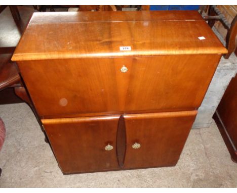 A 30" vintage polished mixed wood drinks cabinet with cantilever top action and mirrored interior over a pair of cupboard doo