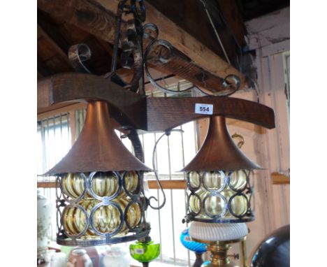 A retro oak and copper hanging centre light with amber glass shades