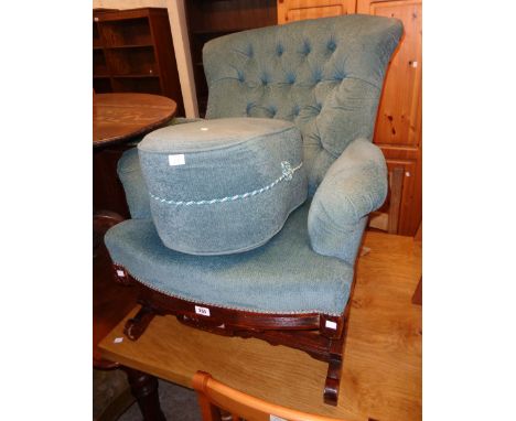 An Edwardian stained walnut framed rocking armchair with later button back frosted blue velour upholstery, set on a decorated