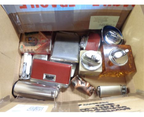 A box containing a quantity of vintage novelty and desk cigarette lighters 