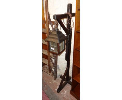 A 20th Century stained oak rustic hangman's standard lamp with leaded glazed lantern on adjustable ratchet support
