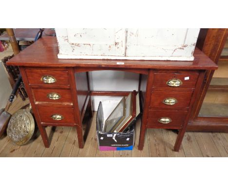 A 3' 9" vintage stained wood kneehole desk with six flanking graduated drawers, set on moulded square front legs