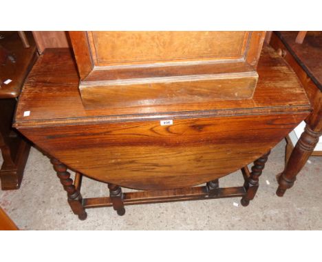 A 3' 4" 1920`s polished oak gateleg dining table, set on barley twist supports