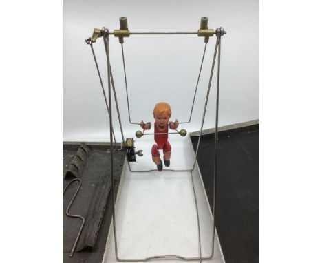 Antique 1920s Tumbling toy with a celluloid doll on a wind up swing acrobatic mechanism in original box( not tested for funct