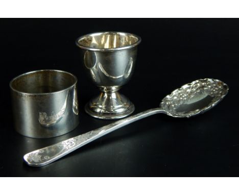 Three items of small silver, a heavy napkin ring engraved with the initials PAE, a berry spoon, and a cup, 4oz overall