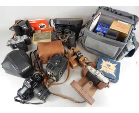 A collection of camera equipment, etc., to include a Canon Eos camera, binoculars, boxed camera, etc.