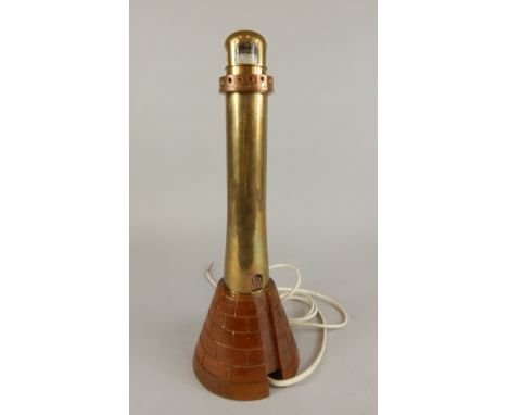 A unusual brass lamp base, modelled in the form of lighthouse with a carved hardwood base, 35cm high.