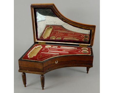 A mid 19thC continental rosewood necessaire, modelled in the form of a grand piano, with ivory keys and a boxwood strung bord