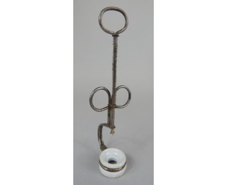 A late 19thC steel and ceramic cherry stoner, with sprung handle. Provenance: Used by Barry Harris, and from his own private 