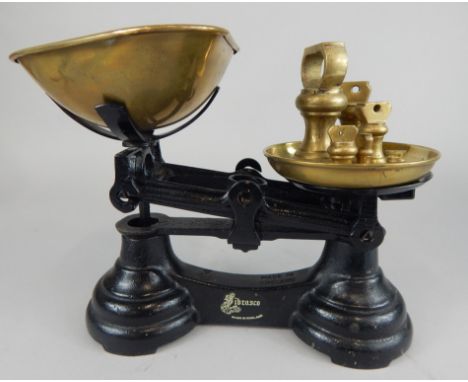 A set of late 19thC/early 20thC Librasco ebonised cast iron scales, stamped Made in England, with brass pans and six weights 