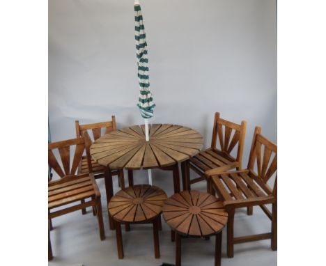 A Gloster Leger Furniture teak circular garden table, parasol, and four chairs.