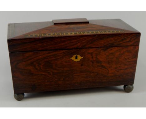 A William IV rosewood and brass inlaid sarcophagus shaped tea caddy, the hinged lid enclosing two separate compartments and a