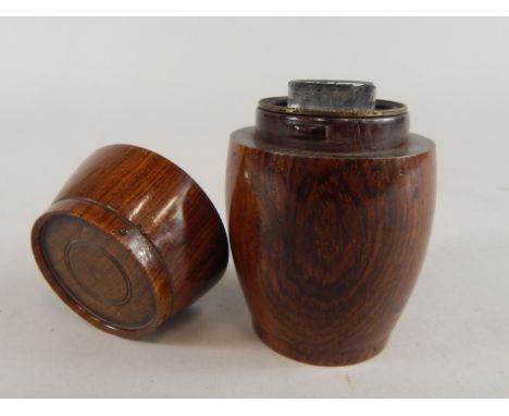A 19thC Lignum Vitae travelling inkwell, turned in the form of a barrel containing a glass well, 9cm high.