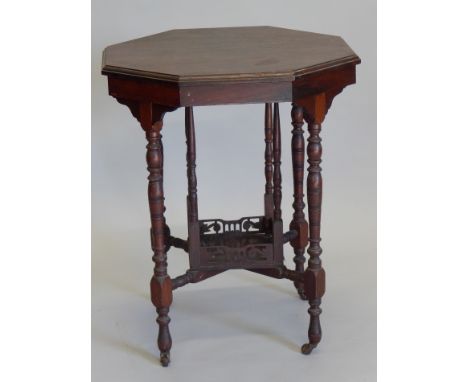 An Edwardian walnut window table, the octagonal top with turned legs, with galleried under tier, and ceramic castors, 61cm wi