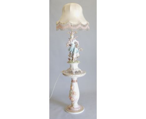 A late 20thC Italian porcelain lamp base, depicting a girl holding flowers with rococo scroll feet, on an associated but simi