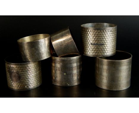 Three pairs of engine turned silver napkin rings, a single napkin ring, various dates, 8¼oz overall