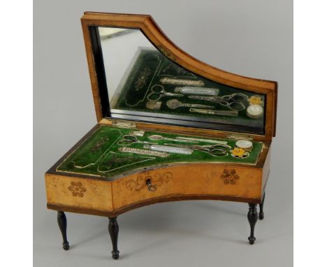 A mid 19thC Continental bird's eye maple musical necessaire, modelled in the form of a grand piano, with ivory keys and marqu