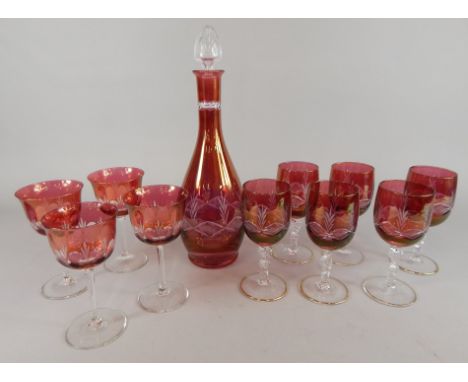 A collection of coloured glass, to include a cut glass ruby tinted decanter and stopper, matching glasses, etc.