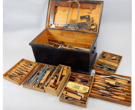 A stained pine tool chest, containing a large quantity of woodworking and other tools, to include sets of chisels, planes, sa