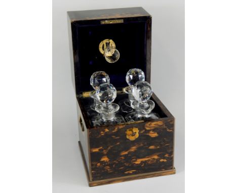 A mid 19thC Coromandel and brass bound decanter box, the hinged lid inset with a vacant brass cartouche, enclosing four squar