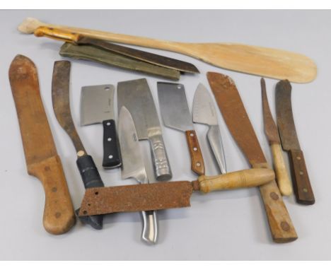 Various machetes, cleavers, and a plain hardwood panel.