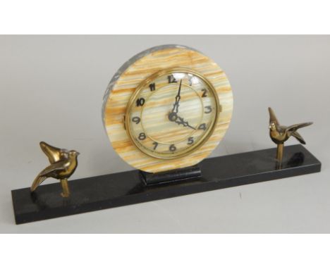 A French onyx and marble mantel clock, the circular dial with pierced hands, the base applied with bronzed spelter birds, 43c