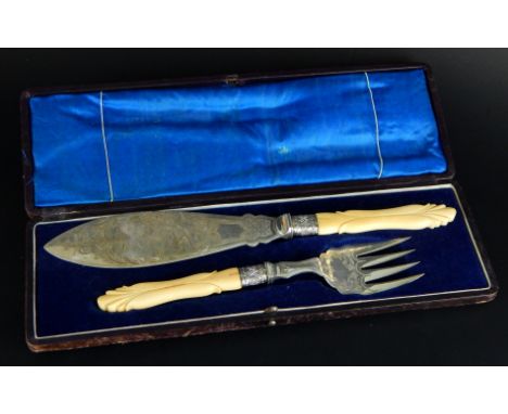 A pair of late 19thC silver plated fish servers, the blade engraved with a sailing ship, each with an ivory handle, in a fitt