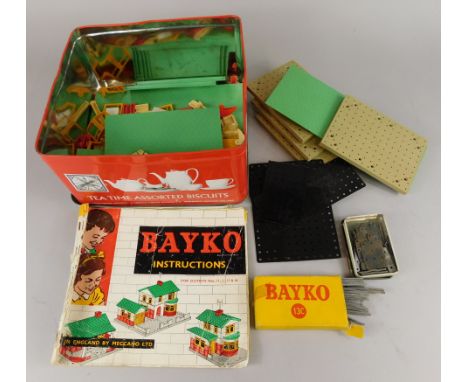 A collection of Bayko bricks, with instructions, in later tin.