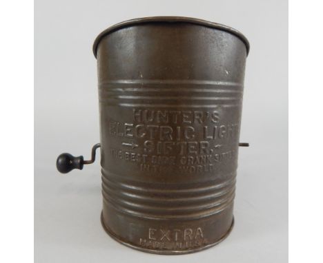 An American Hunters Electric Light flour sifter, stamped to the tin body the best side crank sifter in the world Provenance: 