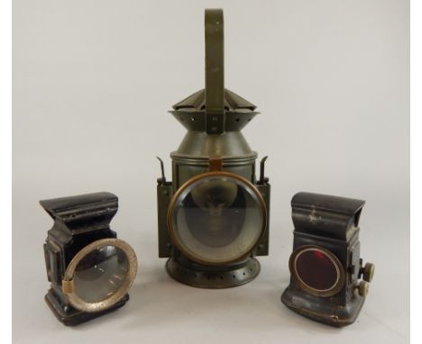 A railway type green painted paraffin lamp, with brass mounts, 32cm high, and two bicycle lamps.