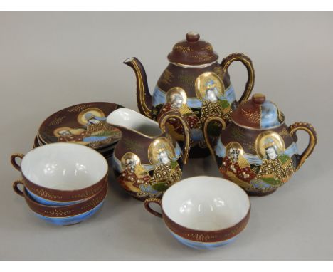 An early 20thC Japanese and eggshell porcelain part tea service, decorated with figures in raised enamel and gilt.