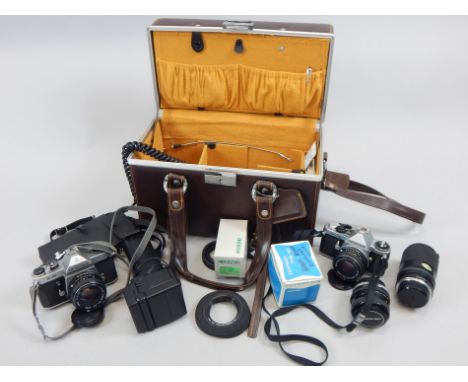 A Pentax ME Super camera, various lens, accessories, etc., and a brown simulated leather camera case.