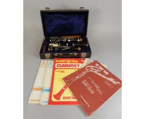 A Czechoslovakian La Couture clarinet, in a fitted case, and some sheet music.