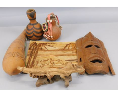 Tribal Art.  A collection of mid to late 20thC tribal items to include an arrow carrier, gourd, carved mask, etc.
