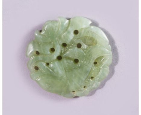 A 19TH CENTURY CHINESE PIERCED AND CARVED JADE ROUNDEL, with carved fish, 5cm.