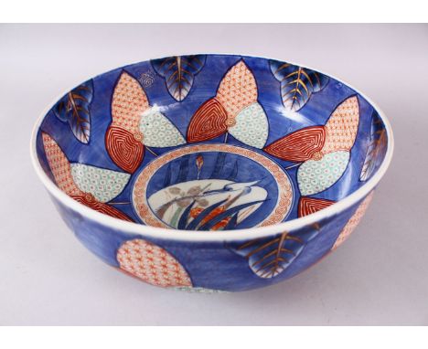A JAPANESE MEIJI PERIOD ARITA / IMARI PORCELAIN PUNCH BOWL, decorated with floral motif with a central panel with a crane amo