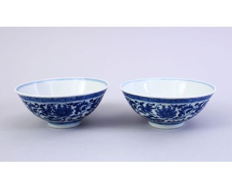 A FINE PAIR OF CHINESE MING STYLE BLUE &amp; WHITE PORCELAIN CUPS, the cups decorated with a central interior roundel of lotu