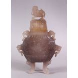 A CHINESE CARVED AGATE VASE AND COVER, with four carved lion dog head handles and rings, stood