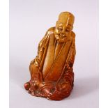 A CHINESE CARVE3D SOAPSTONE FIGURE OF A JOLLY MAN, in seated position, 11cm