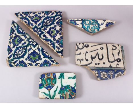 A GROUP OF FIVE 16TH/17TH CENTURY IZNIK AND DAMASCUS TILE FRAGMENTS.