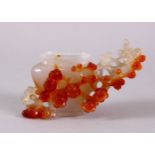 A CHINESE CARVED AGATE PRUNUS VASE, with carved prunus decoration in relief, 11cm wide, no cover