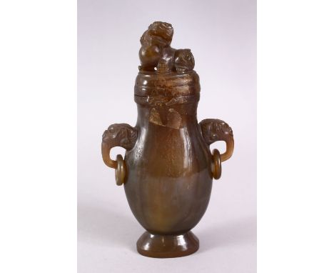 A CHINESE CARVED JADE / JADE LIKE TWIN HANDLE VASE &amp; COVER, with twin carved lion handles and rings, with a lion dog fini