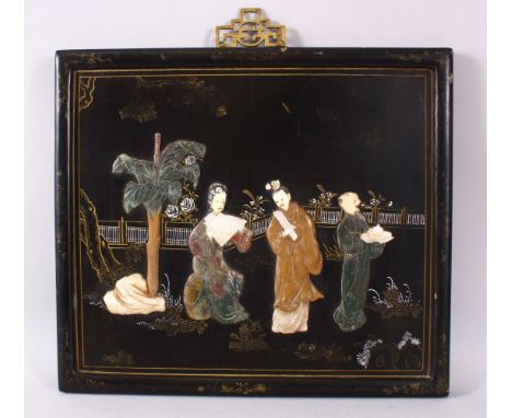 A CHINESE CARVED HARD STONE INLAID PANEL, depicting figures in a garden setting upon a lacquer ground, 35.5cm x 40cm