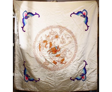 A LARGE CHINESE EMBROIDERED SILK DRAGON &amp; BAT PANEL, depicting a central embroidery of a dragon chasing the pearl, with b