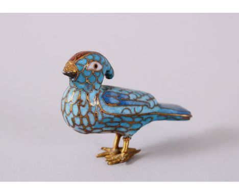 A PERSIAN / ISLAMIC ENAMEL MODEL OF A BIRD, with a turquoise ground, 6cm wide.