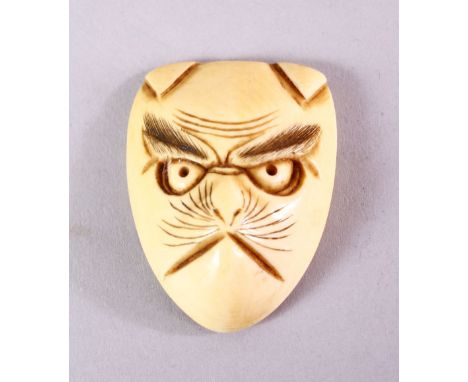 A JAPANESE MEIJI PERIOD CARVED IVORY NETSUKE MASK OF A FOX - KITSUNE, himotoshi formed to the verso with an artist signature,