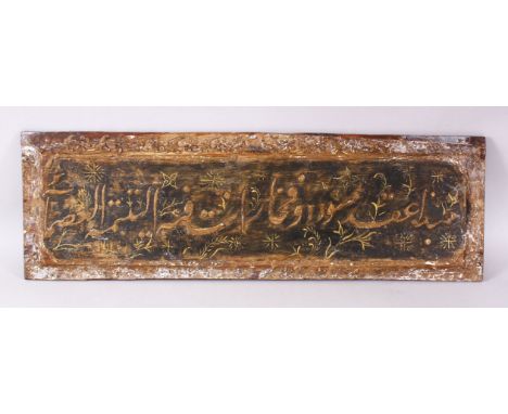 AN 18TH CENTURY OTTOMAN PAINTED WOOD PANEL, depicting calligraphy and stylised flowers, 84cm x 26cm.