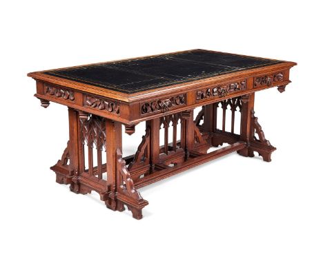 A MID VICTORIAN OAK LIBRARY TABLE IN THE GOTHIC TASTE RETAILED BY JAMES SHOOLBRED & CO, LONDON, CIRCA 1860 The top inset with