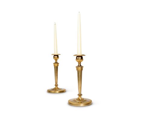A PAIR OF EMPIRE REVIVAL GILT BRONZE CANDLESTICKS  LATE 19TH CENTURY  With facetted stem on paw feet  26cm high, bases 13cm d