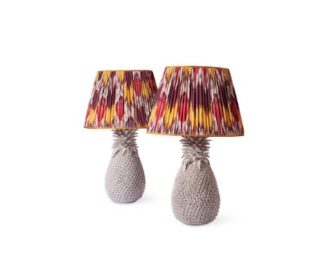 A PAIR OF WHITE CERAMIC PINEAPPLE LAMPS  MODERN  With pleated Ikat shades bases 51cm high including electric fitments, 88cm h